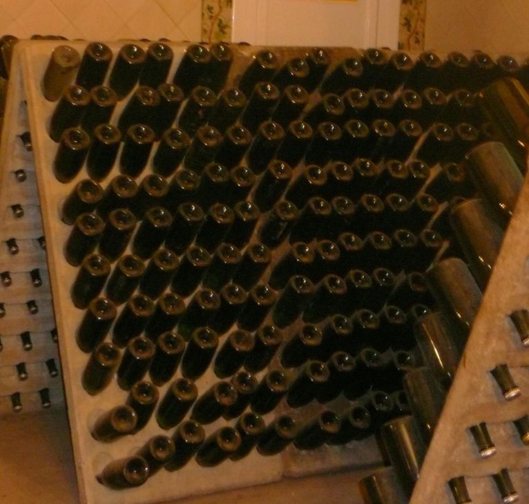 Wine bottles aging in underground cellar